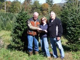 Case Pieterman, Cindy DeMarco and Steve Strickland select Christmas Trees for the Club's annual Christmas Tree sale.